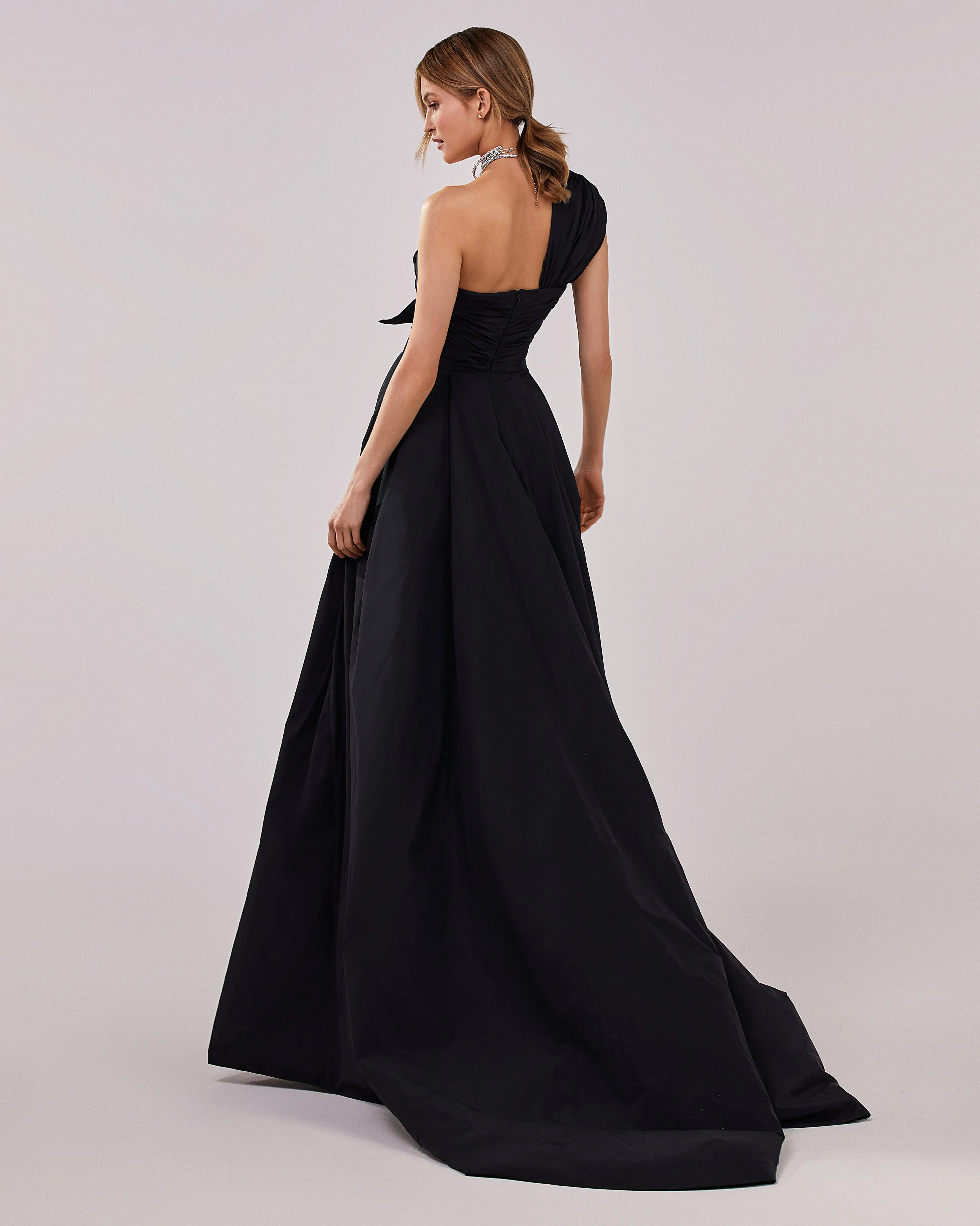 Black taffeta evening gown with a high slit and one-shoulder wrap top